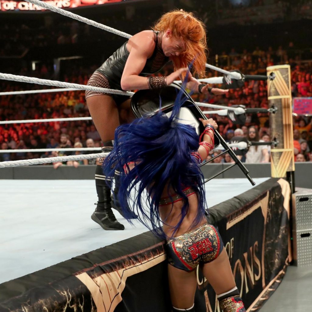 Sasha Banks jams a chair into Becky Lynch's abdomen
