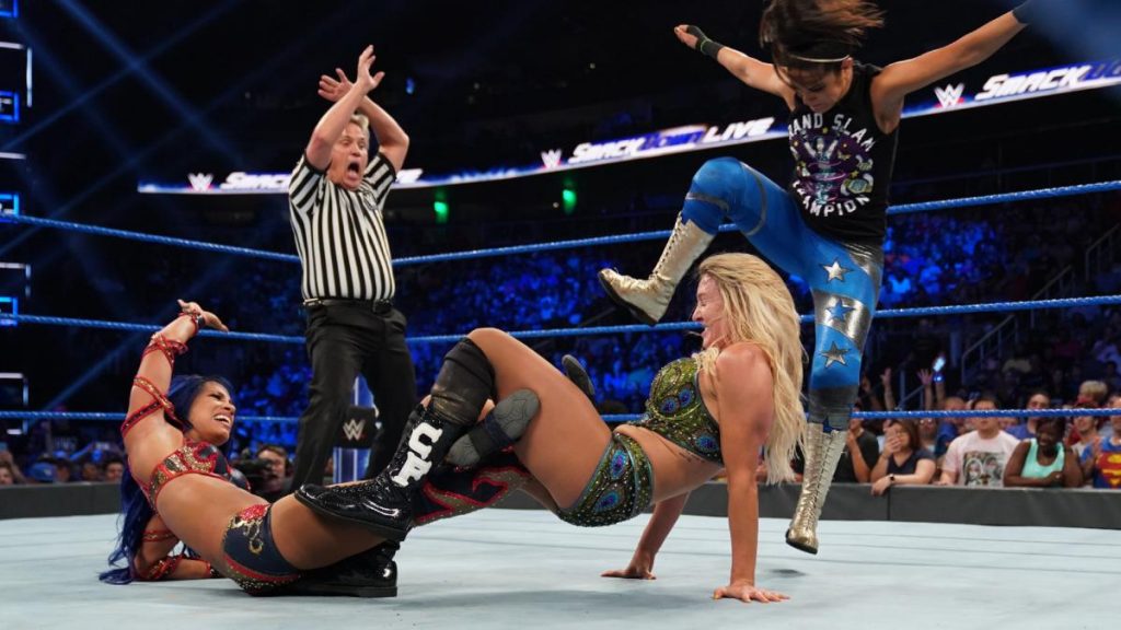 Bayley gets Sasha Banks disqualified by kicking Charlotte Flair in the head
