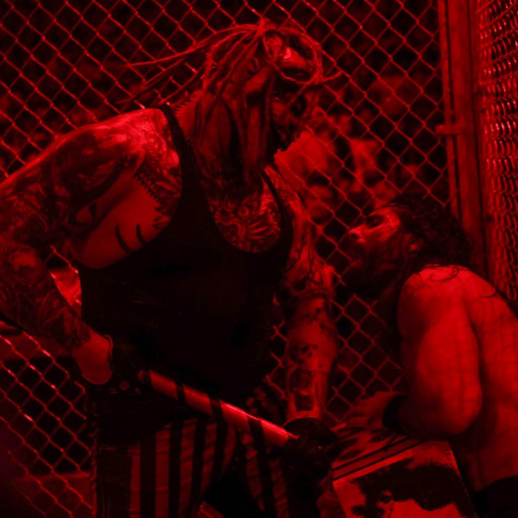 The Fiend drives a mallet into Rollins abdomen