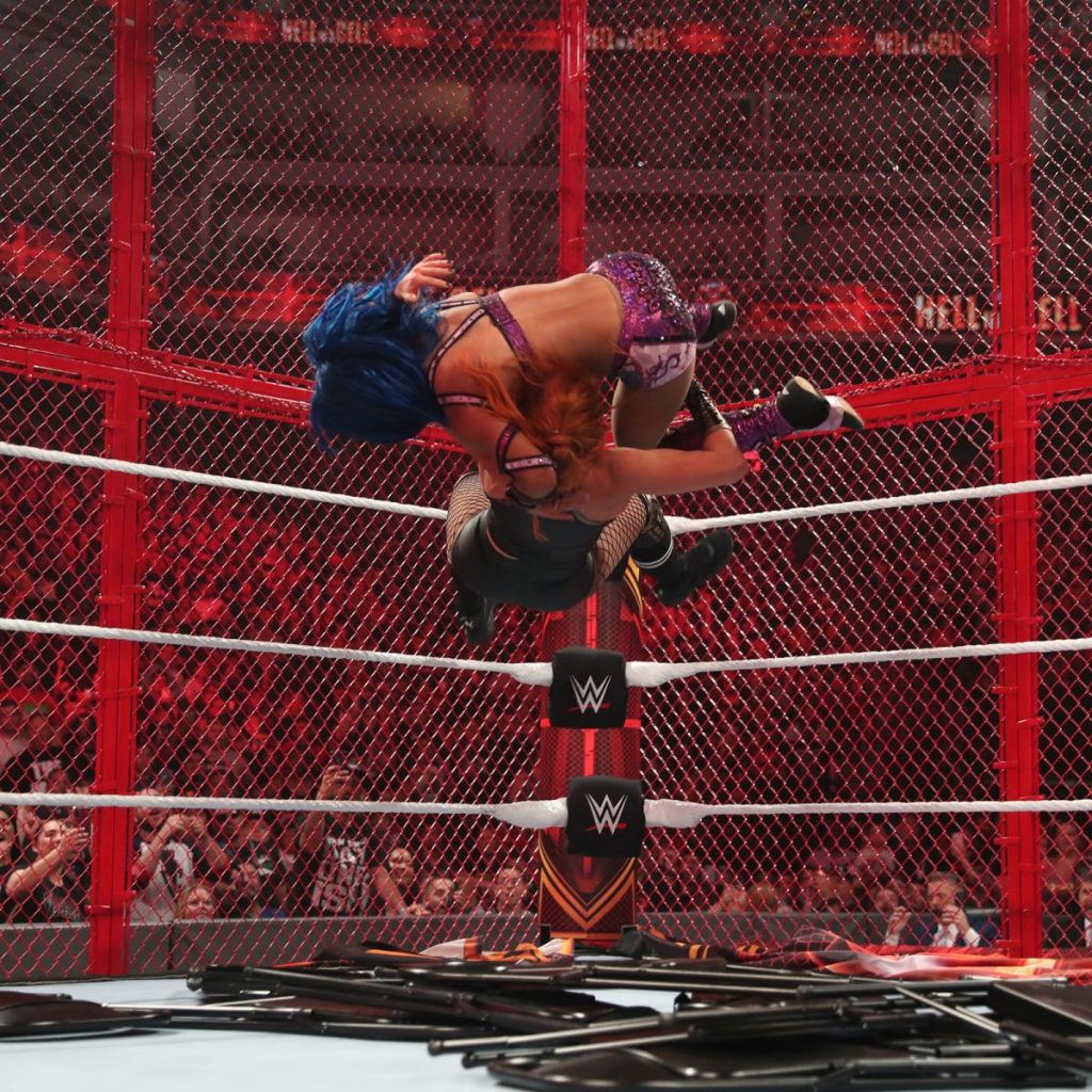 Becky Lynch Bexploder's Sasha Banks from the turnbuckle onto a pile of chairs