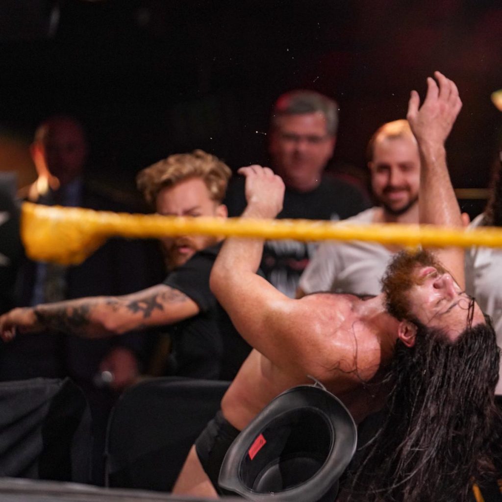 Tyler Bate punches Cameron Grimes