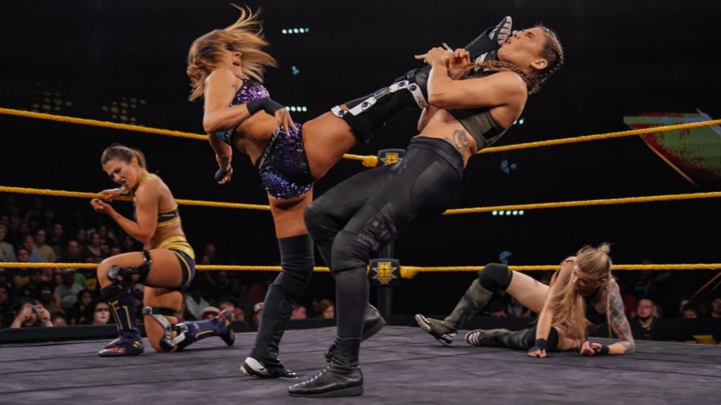 Dakota Kai kicks Marina Shafir with Tegan Nox and Jessamyn Duke in the background