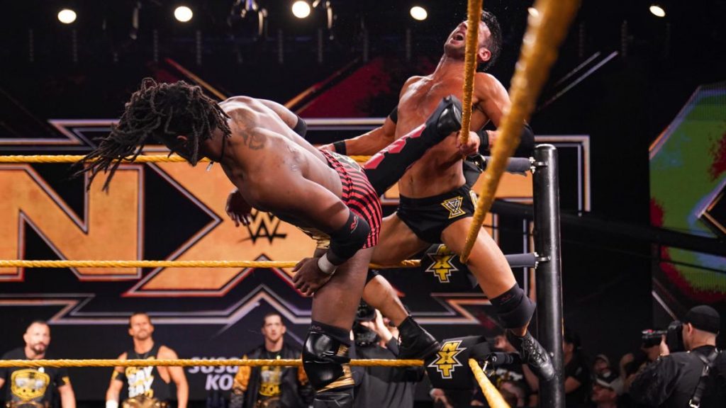 Isaiah 'Swerve' Scott kicks Roderick Strong in the corner while the rest of Undisputed ERA look on