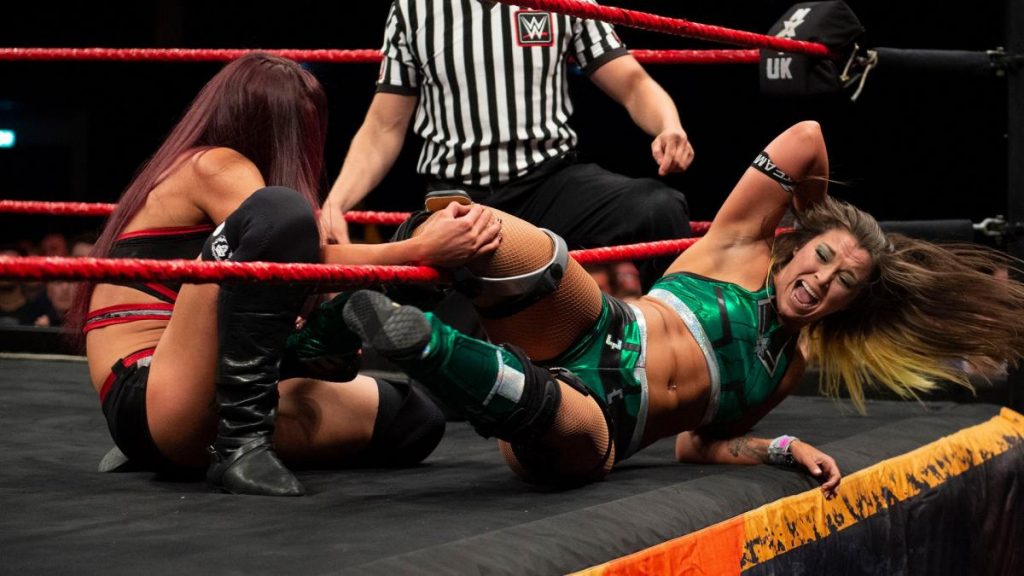 Kay Lee Ray wraps Tegan Nox' leg around the ropes
