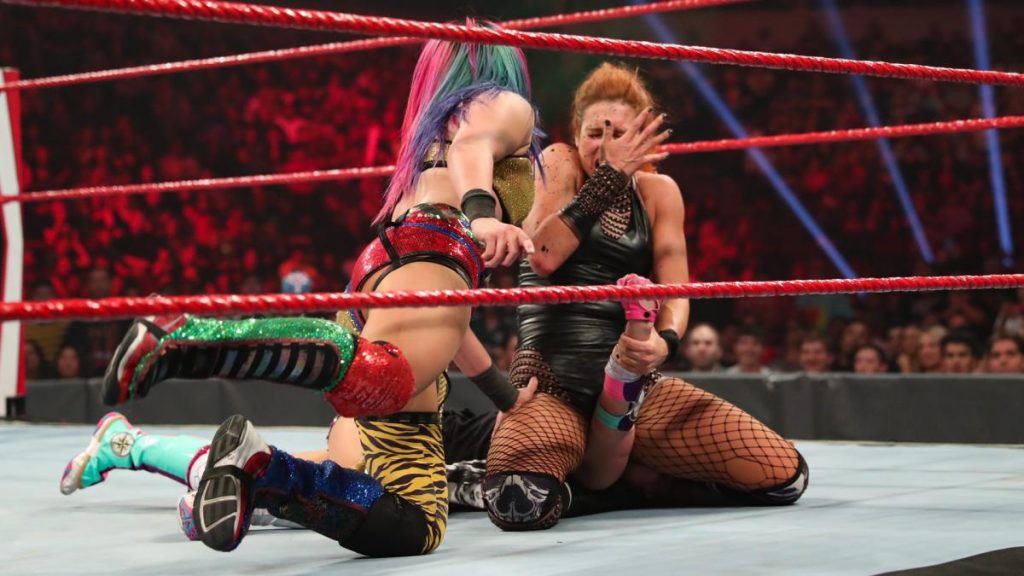 Asuka sprays the green mist in Becky Lynch's face