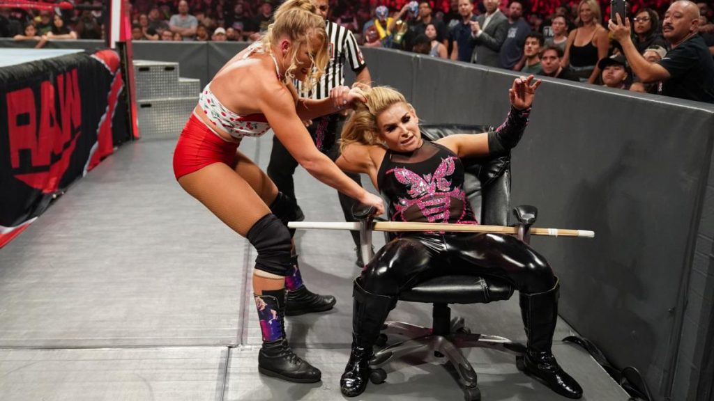 Lacey Evans traps Natalya in a chair with a kendo stick