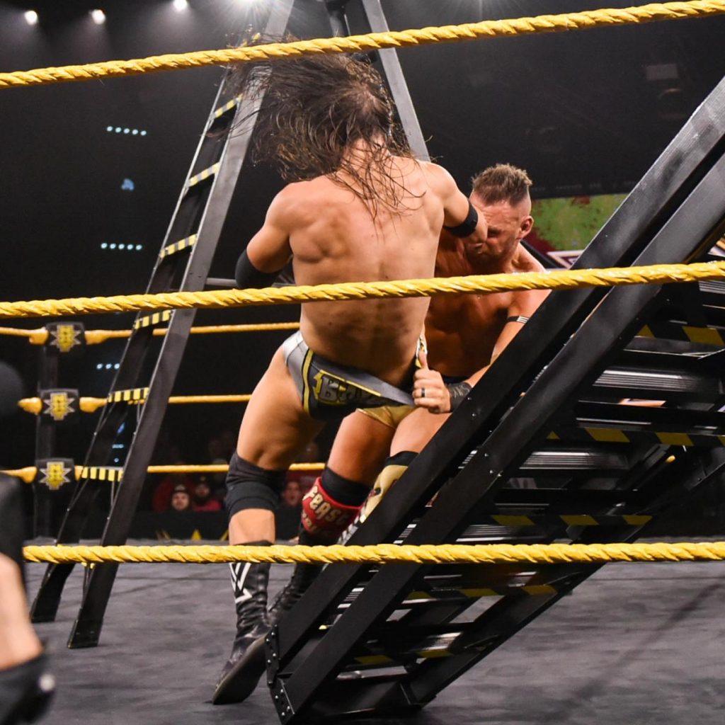 Adam Cole is chokeslammed onto a ladder by Dominik Dijakovic