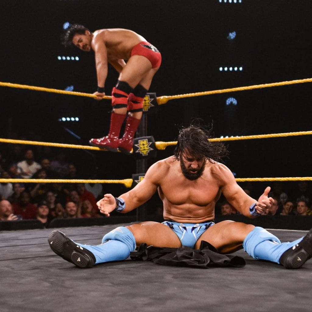 Tony Nese staring at the stripper pants he just powerbombed, with Angel Garza in the background