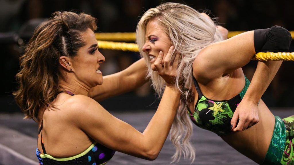 Dakota Kai makes Cadice LeRae look at her while LeRae in in the ropes