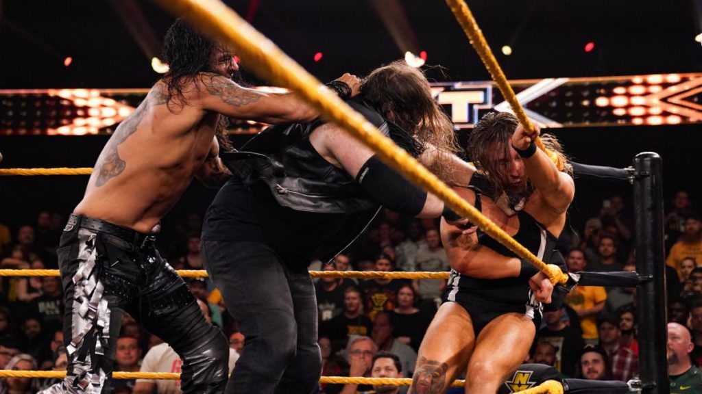 Damian Priest attacks Killian Dain who was attacking Pete Dunne in the corner