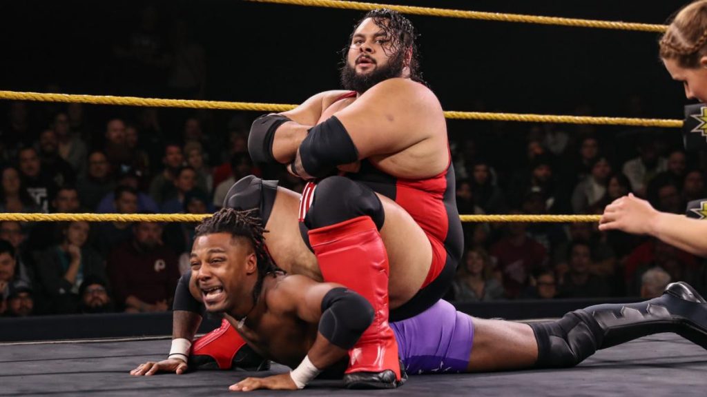 Bronson Reed sits on Isaiah 'Swerve' Scott's back