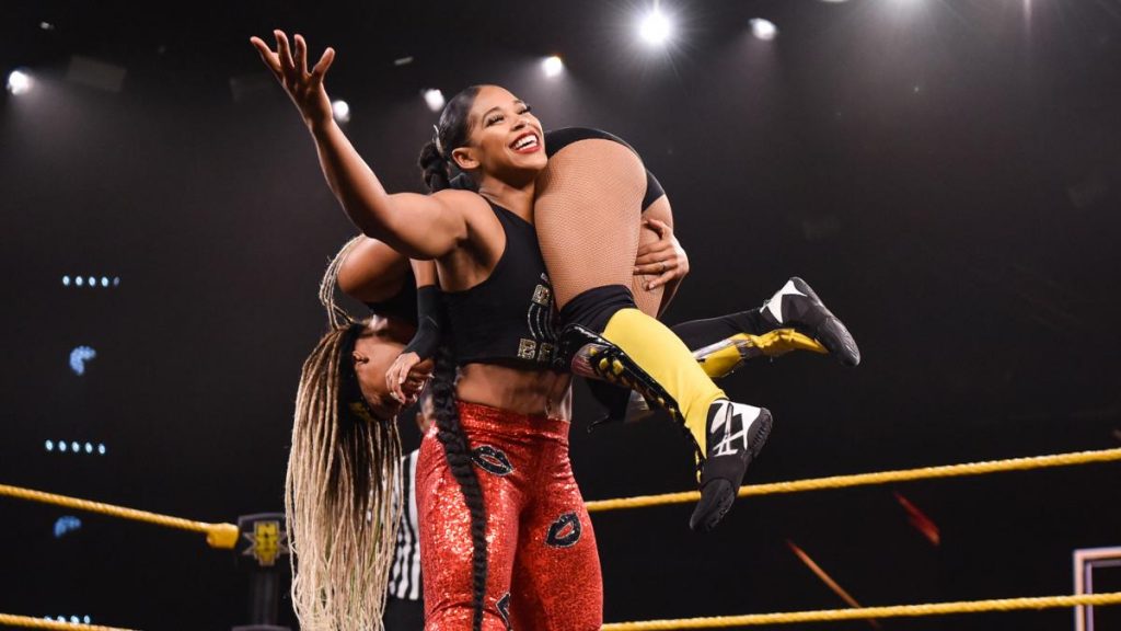 Bianca Belair with Kayden Carter on her shoulder