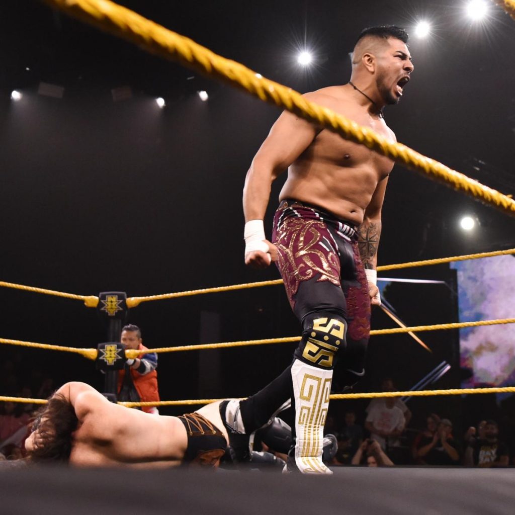 Raul Mendoza celebrates with Camero Grimes and Kushida i the background