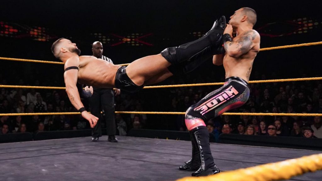 Finn Balor dropkicks Joaquin Wilde