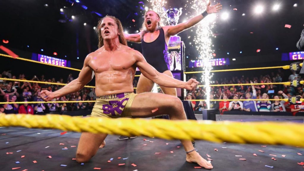Matt Riddle and Pete Dunne with the winners pyro