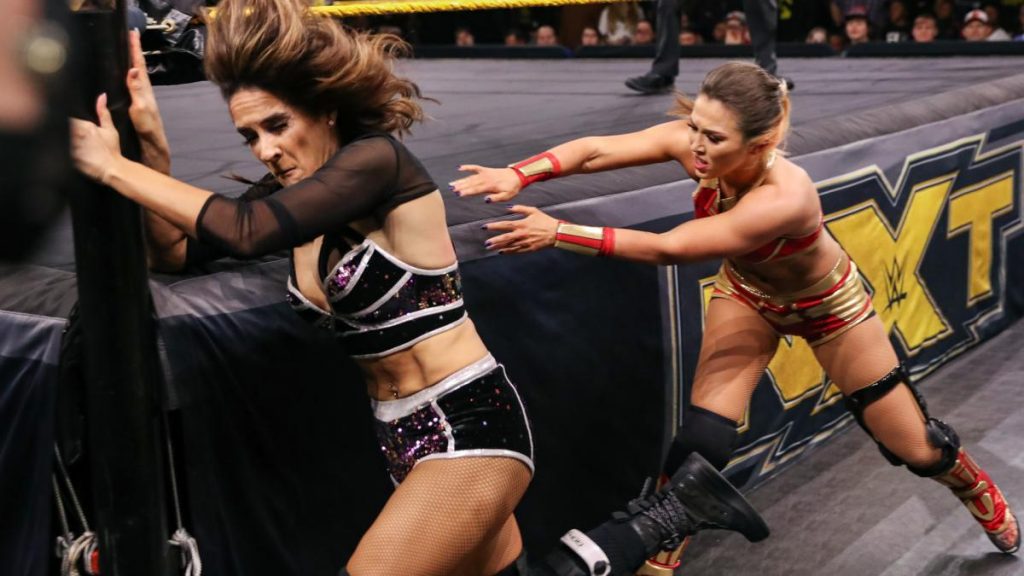 Tegan ox shoves Dakota Kai into the ringpost