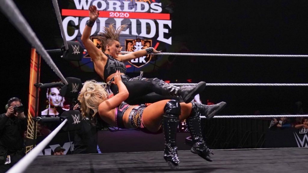 Toni Storm suplexes Rhea RIpley into the corner
