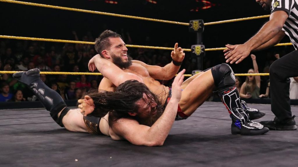 Johnny Gargano tries to make Cameron Grimes submit