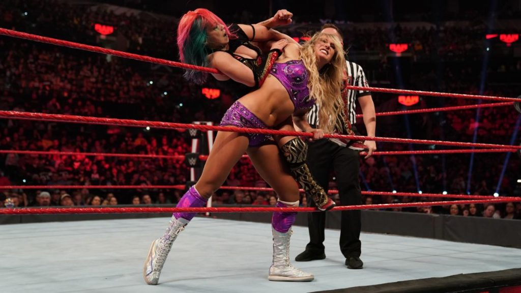 Asuka stretches Charlotte Flair
