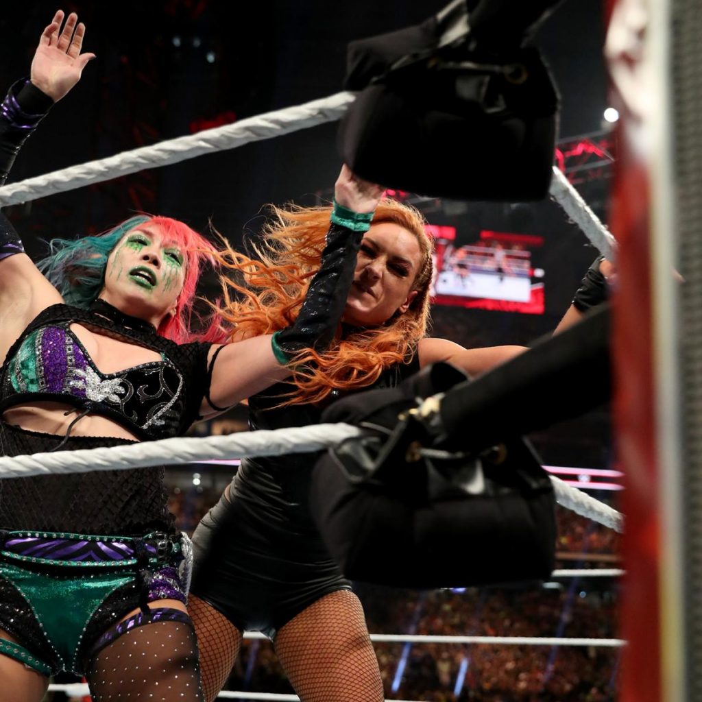Becky Lych smashes Asuka's head into a turnbuckle