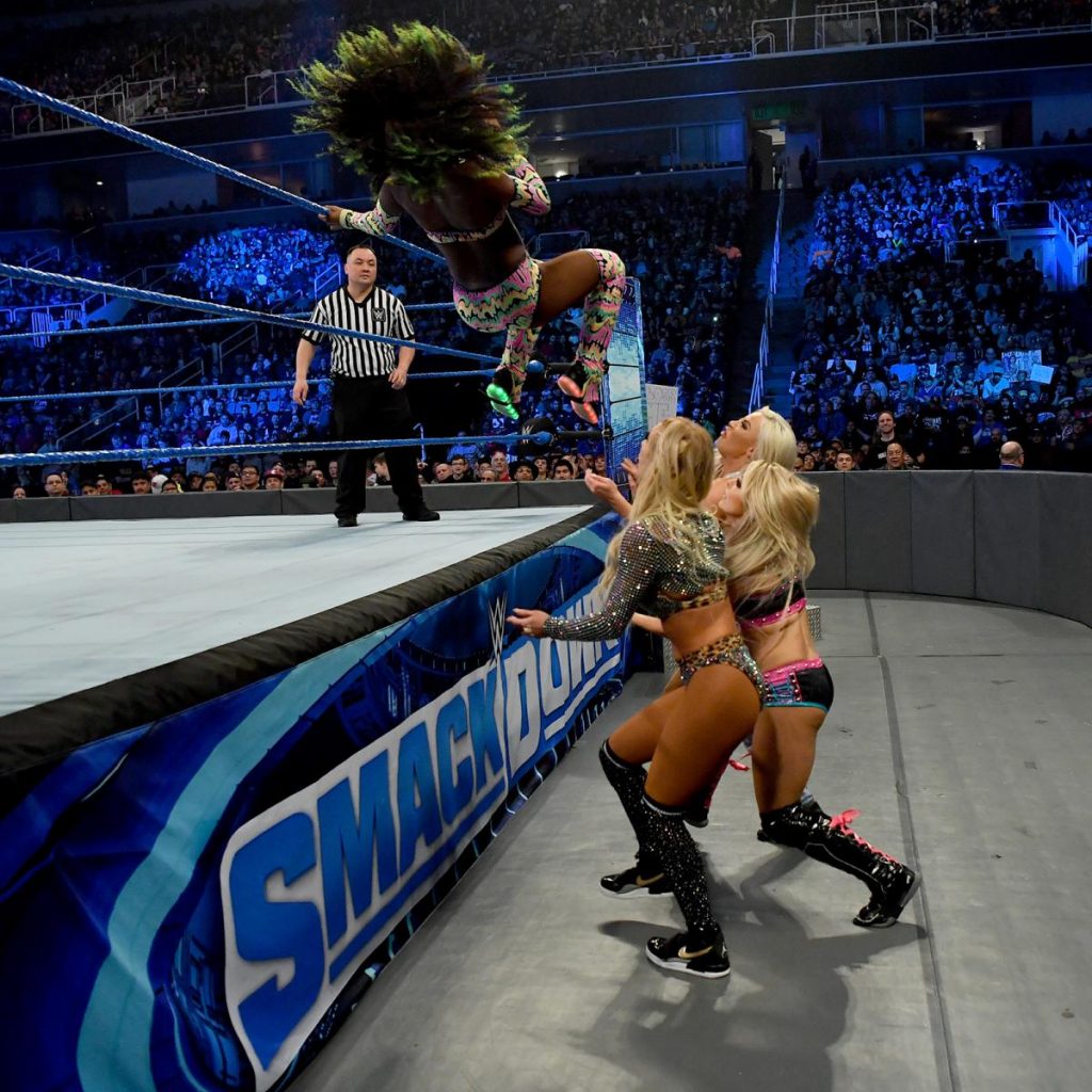 Naomi flies over the top rope onto Carmella, Dana Brooke, and Alexa Bliss