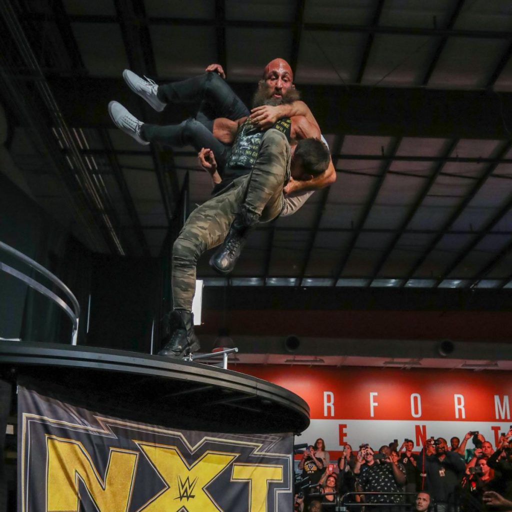 Tommaso Ciampa jumps off the balcony holding Johnny Gargano