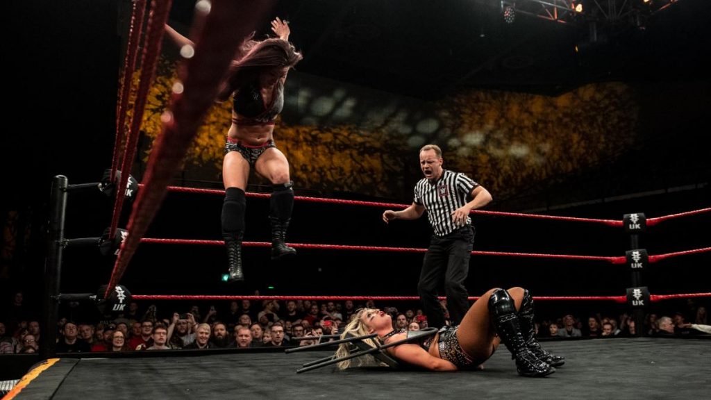 Kay Lee Ray jumps on the chair round Toni Storm's neck