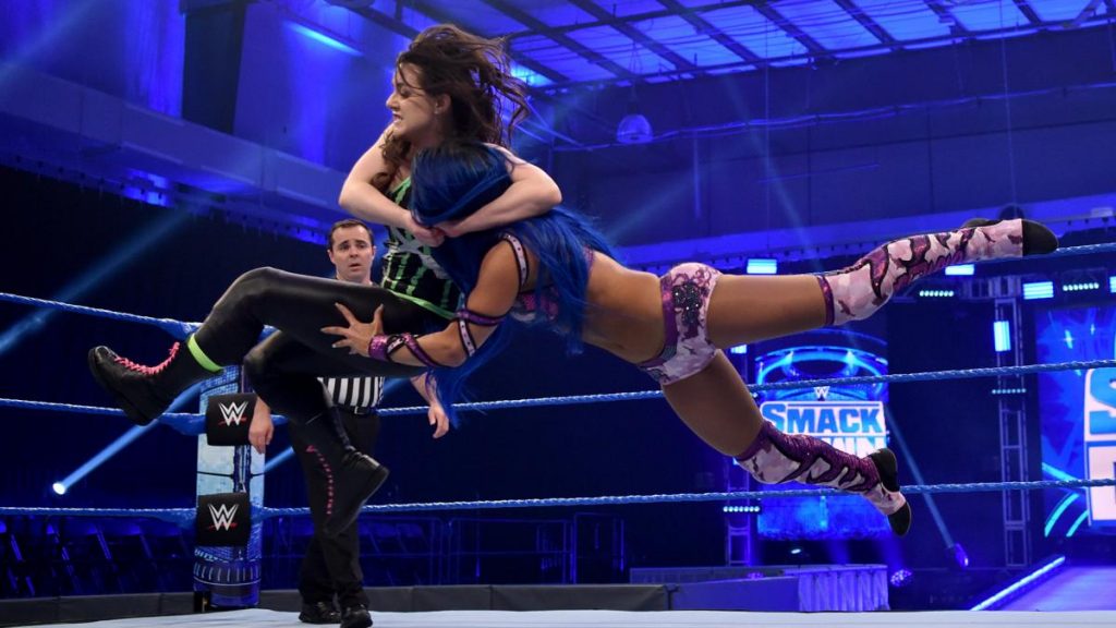 Nikki Cross with a bulldog on Sasha Banks