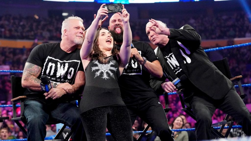 Nikki Cross poses for a selfie with nWo members Hall, Nash, and Waltman