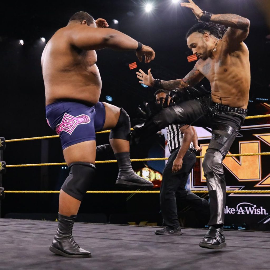 Keith Lee and Damian Priest exchange kicks