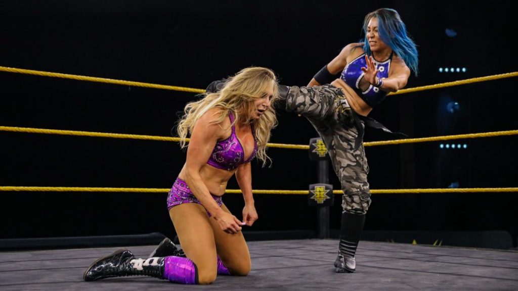 Mia Yim kicks Charlotte Flair