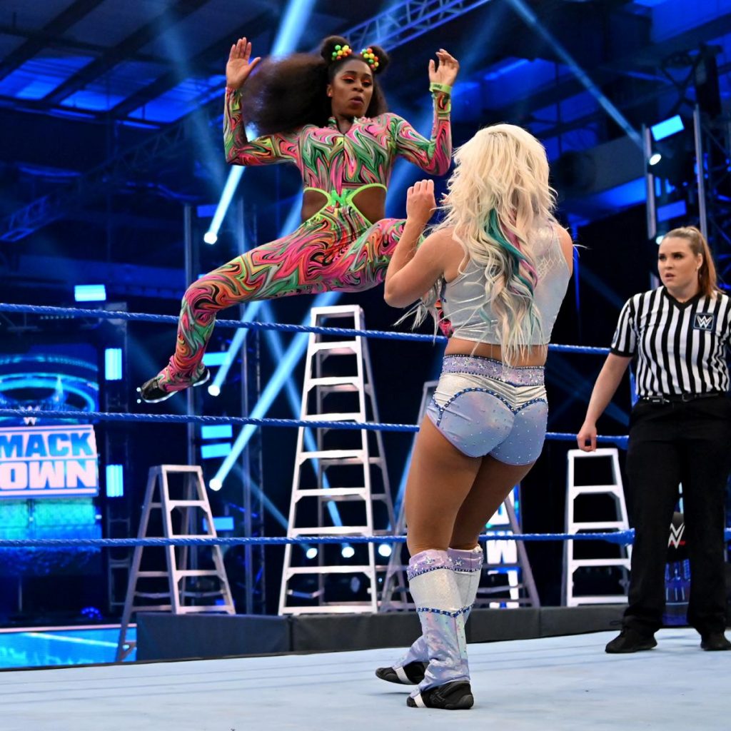Naomi launches herself at Dana Brooke with a kick