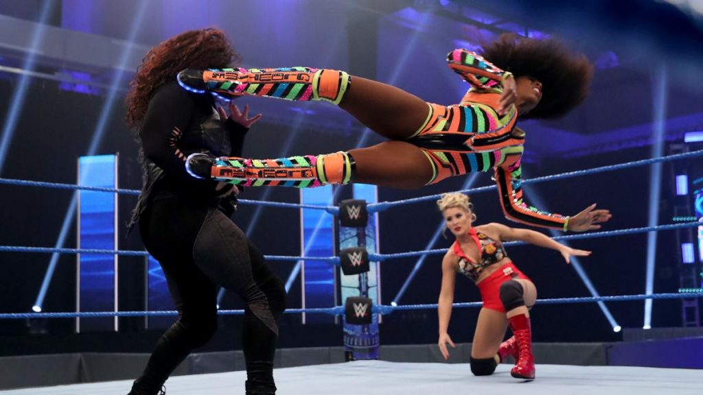 Naomi dropkicks Tamina with Lacey Evans in the background