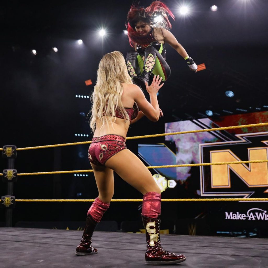 Io Shirai missile dropkicks Charlotte Flair