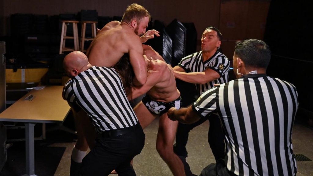 Referees try to separate Matt Riddle and Timothy Thatcher
