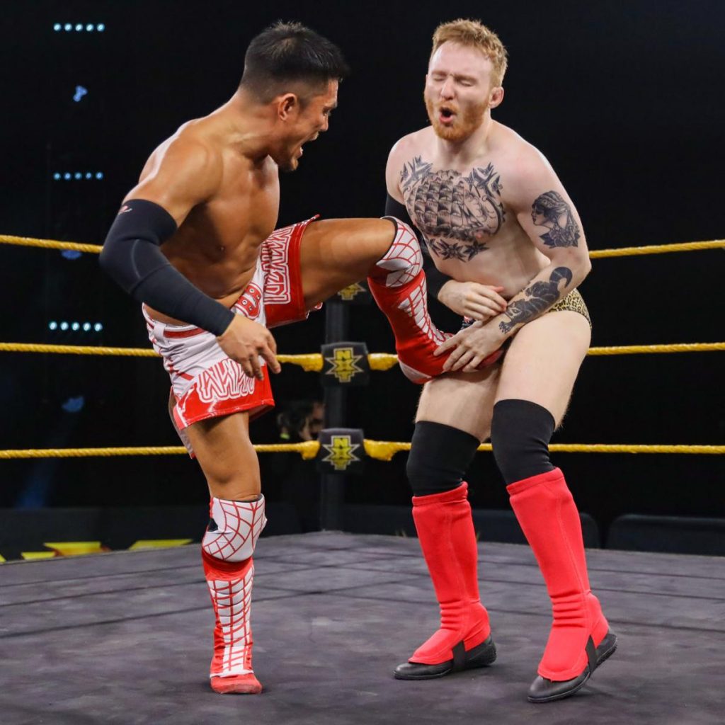 Akira Tozawa kics Jack Gallagher in the stomach in their cruiserweight title tournament match