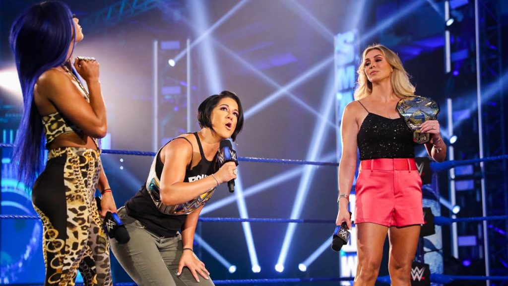 Sasha Banks and Bayley arguing with Charlotte Flair