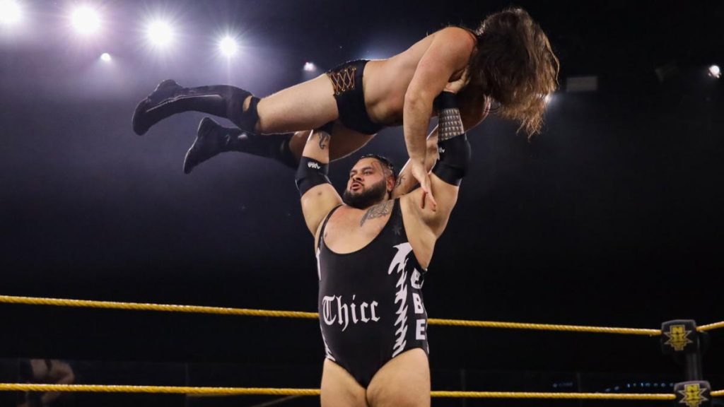 Bronson Reed holds Cameron Grimes over his head