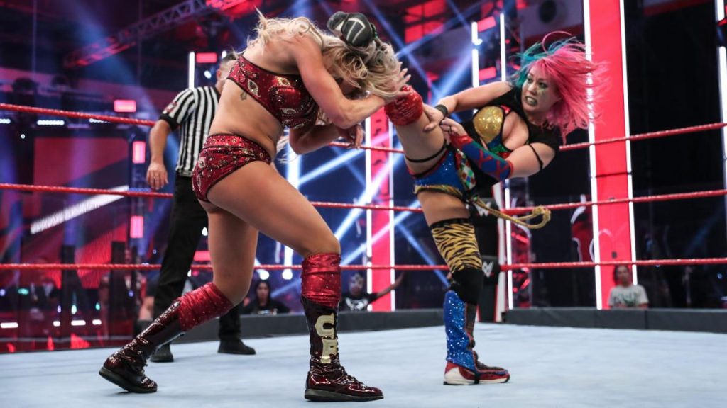 Asuka kicks Charlotte Flair in the head