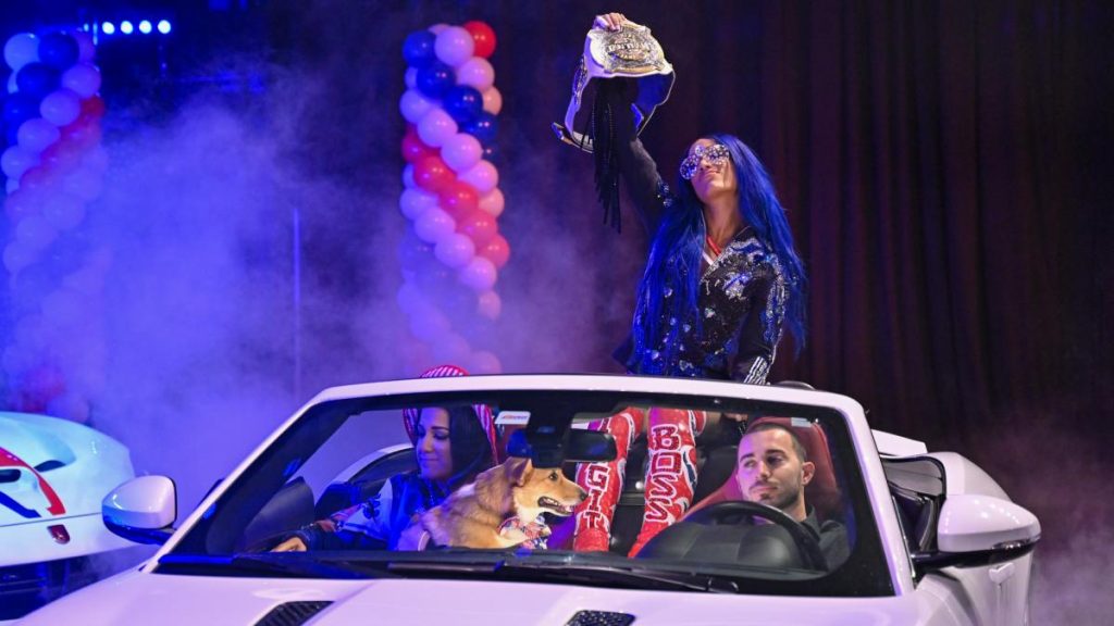Sasha Banks is driven to the ring with Bayley and Banks' dog.
