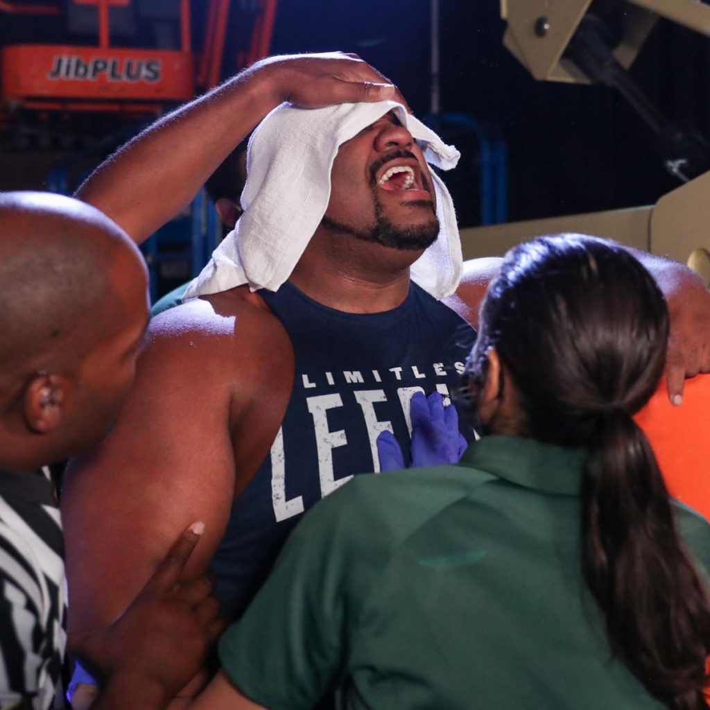Keith Lee is tended to by medics after Karrion Kross and Scarlett's fireball attack