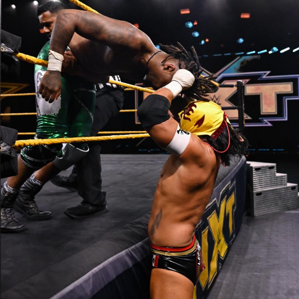 Santos Escobar headbutts Swerve with the Lucha mask on