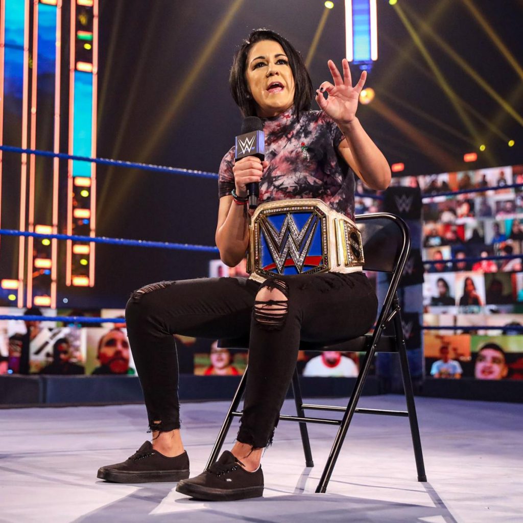 Bayley sat on a chair in the ring