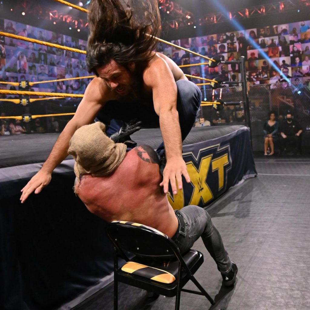 Cameron Grimes give Dexter Lumis a Cave In on a chair