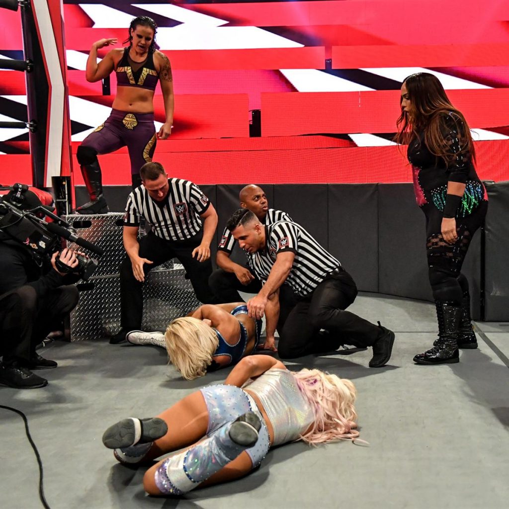 Shayna Baszler and Nia Jax look at the remnants of their fallen Survivor Series team after Baszler injured Mandy Rose
