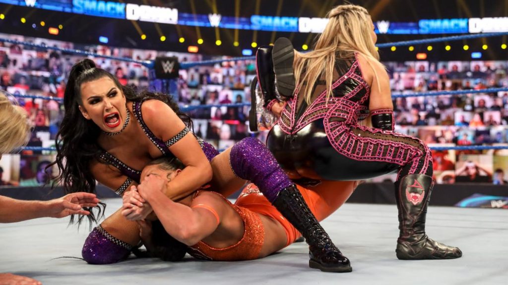 Natalya and Billie Kay try to tap out Bianca Belair