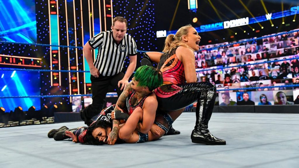 Ruby Riott and Natalya simultaneously try to submit Zelina Vega