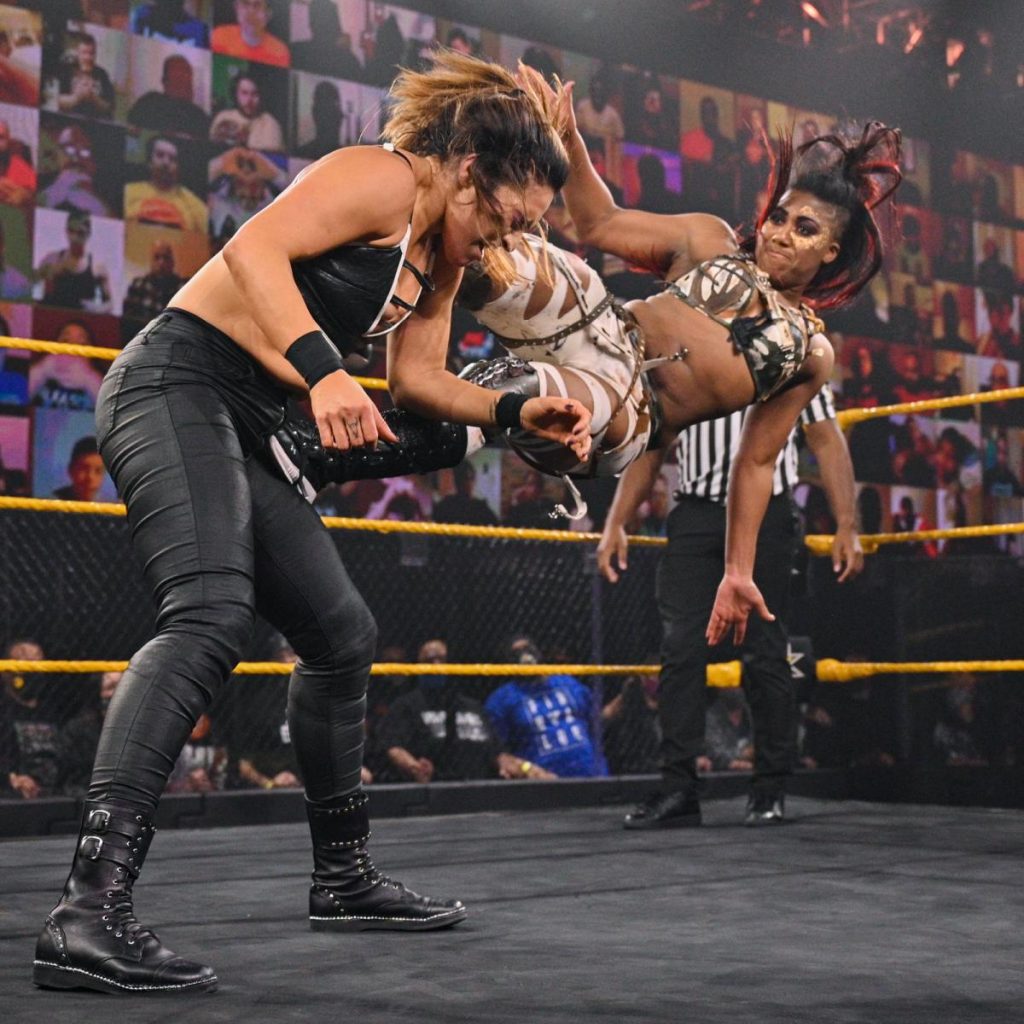 Ember Moon dropkicks Raquel Gonzalez