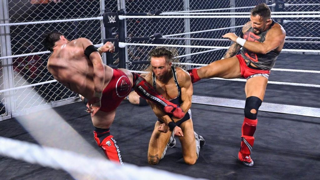 Kyle O'Reilly and Bobby Fish double team Pete Dunne