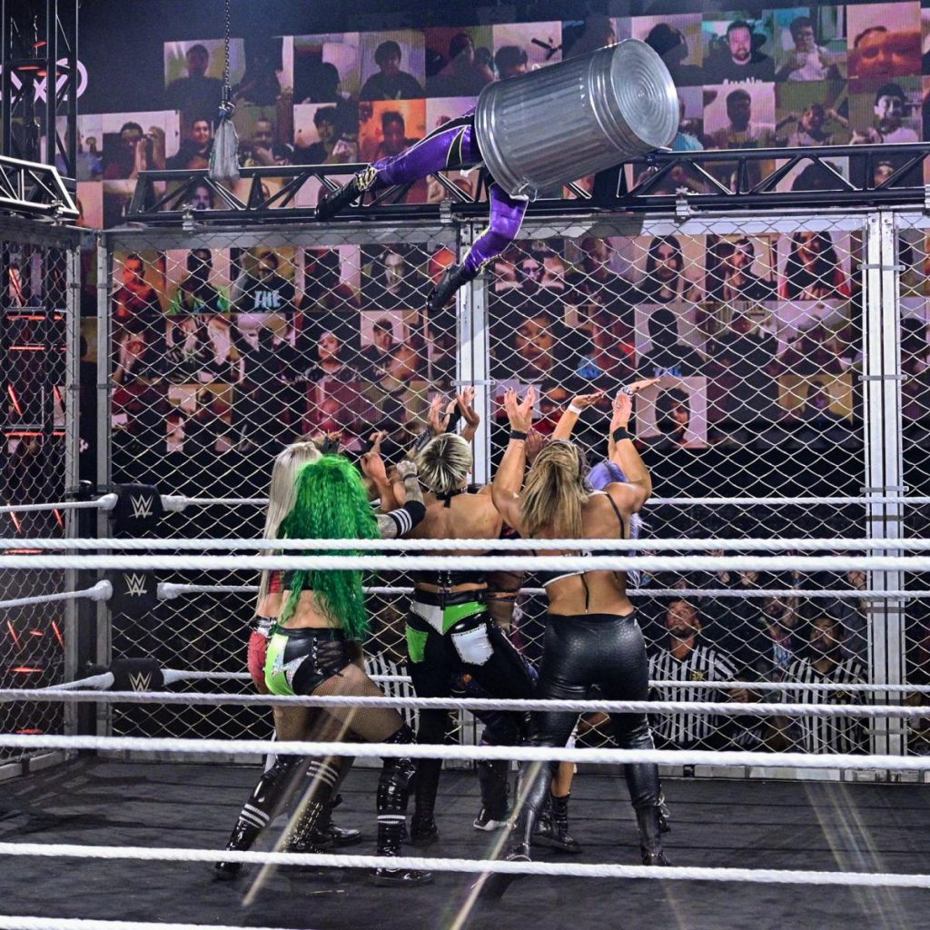 Io Shirai enters the WarGames match from the top of the cage, inside a trashcan, into everyone else